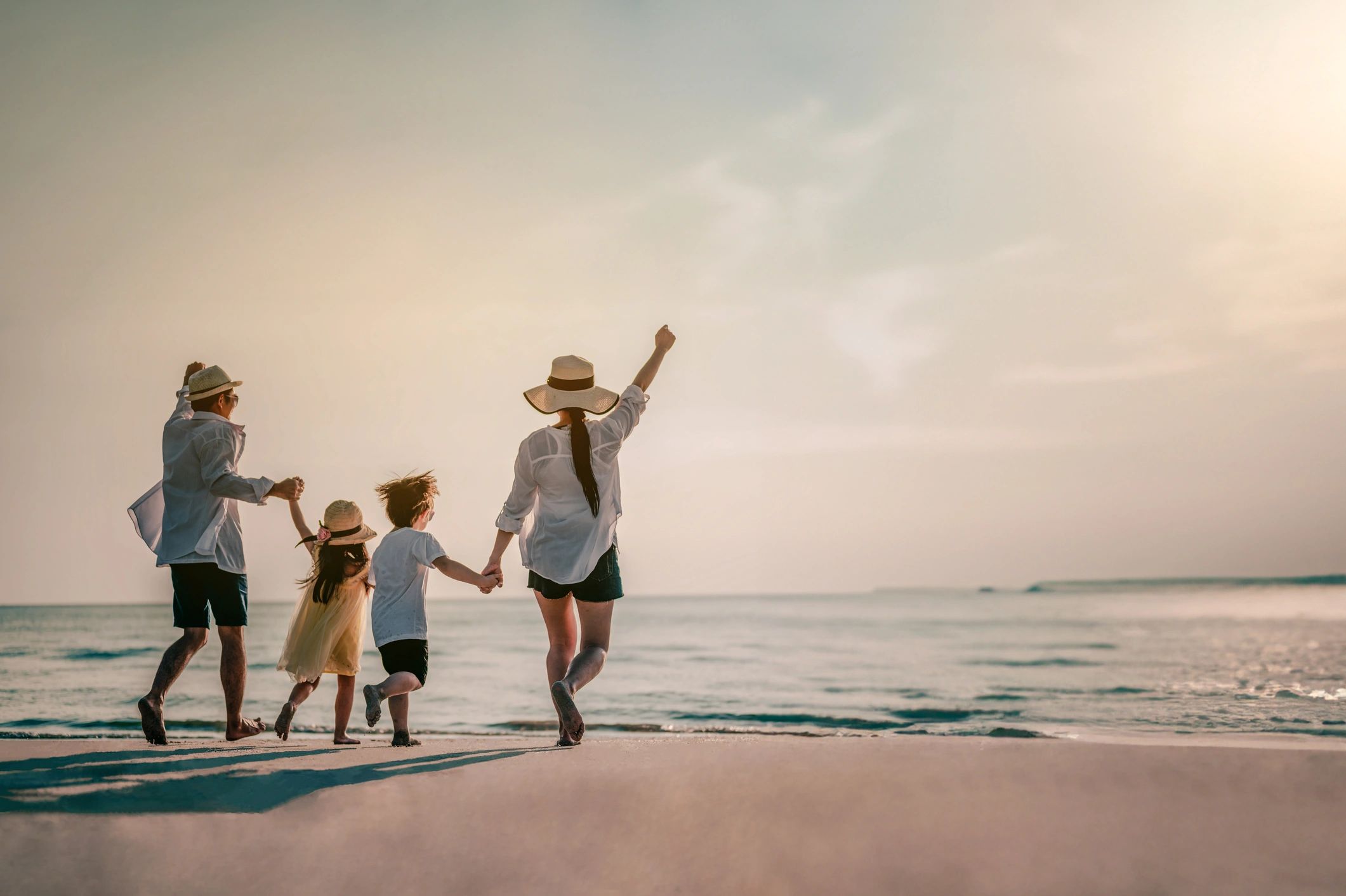 Family enjoying beach at sunset in Southwest Florida
